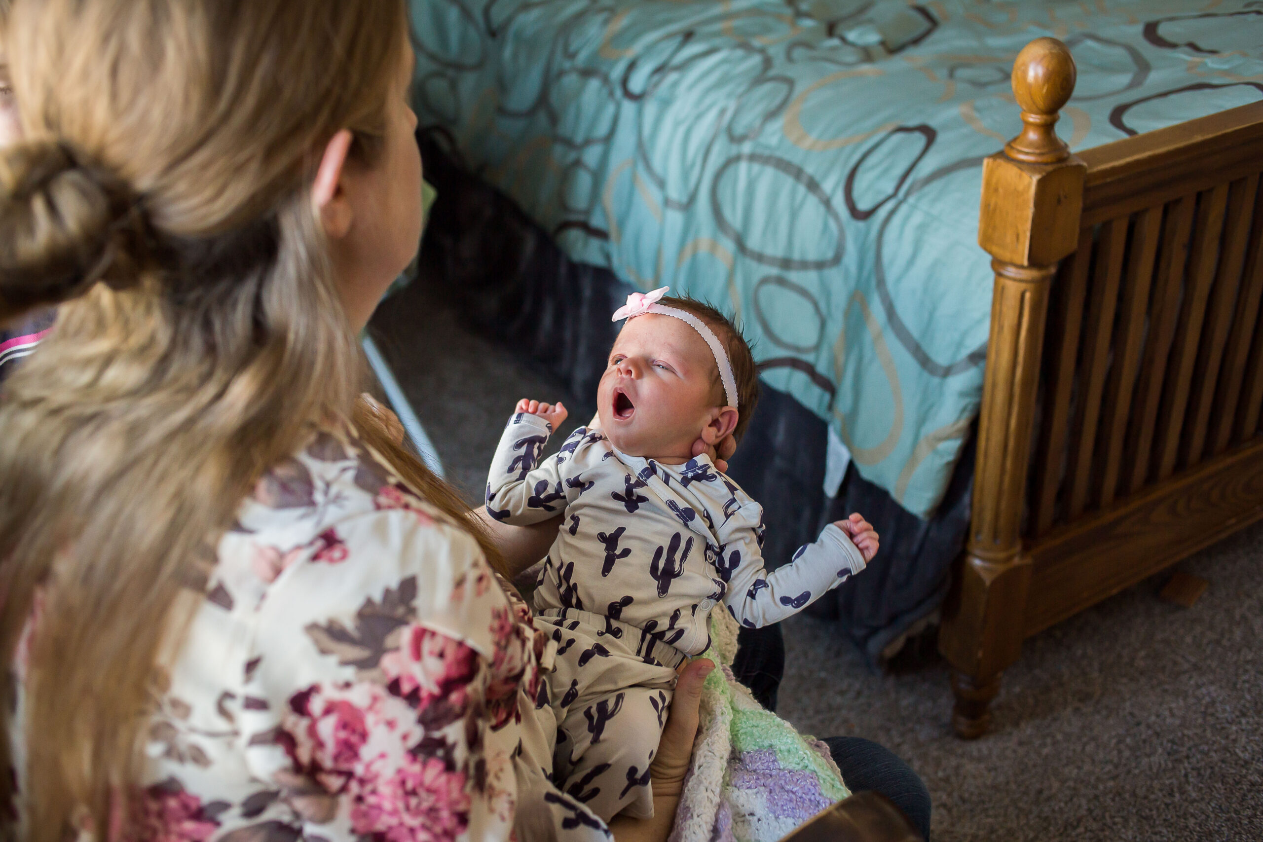 Julia gazes at baby Sarah at a newborn session in Mapleton