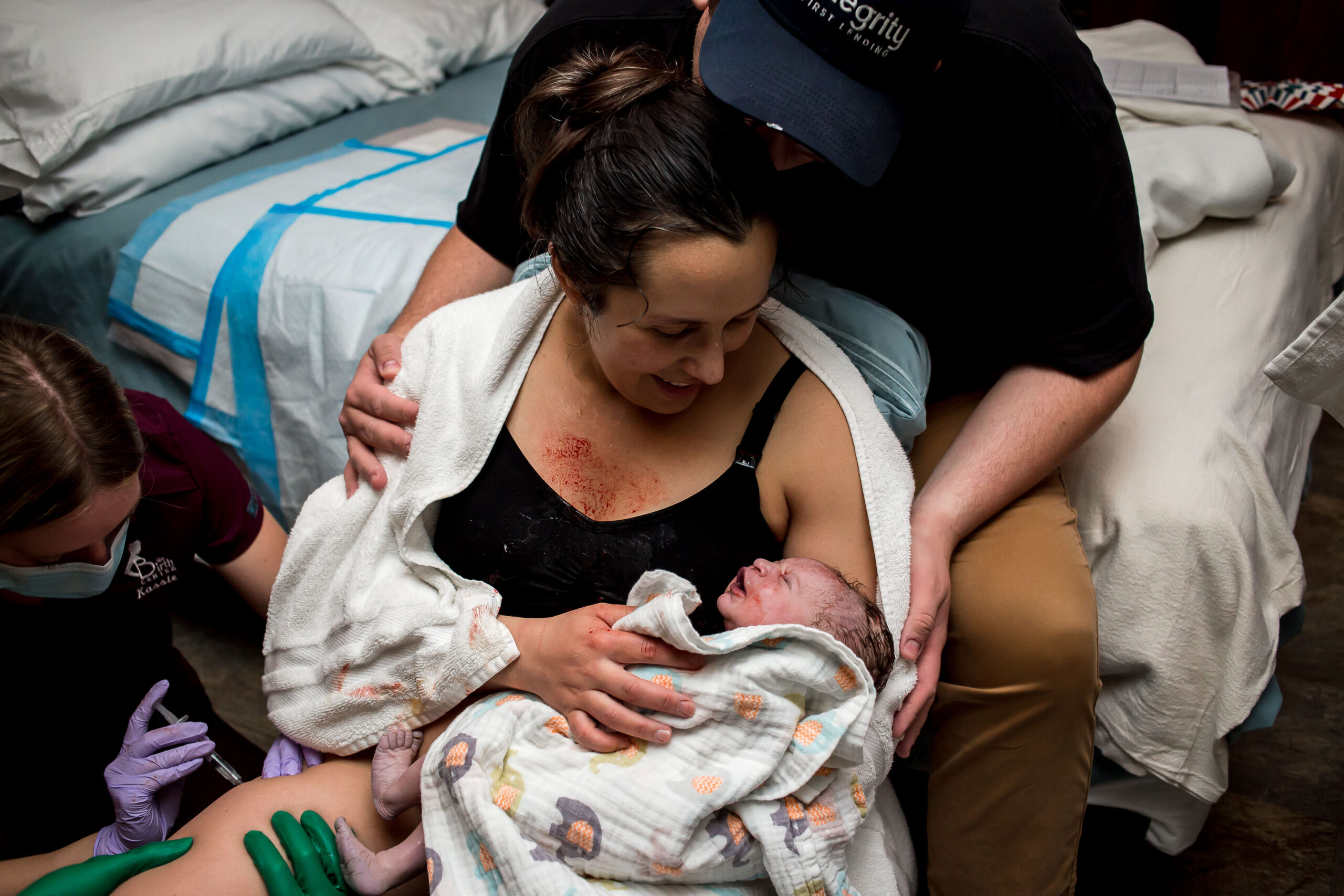 Mother gazing into her baby's face after giving birth | Utah Birth Photographer